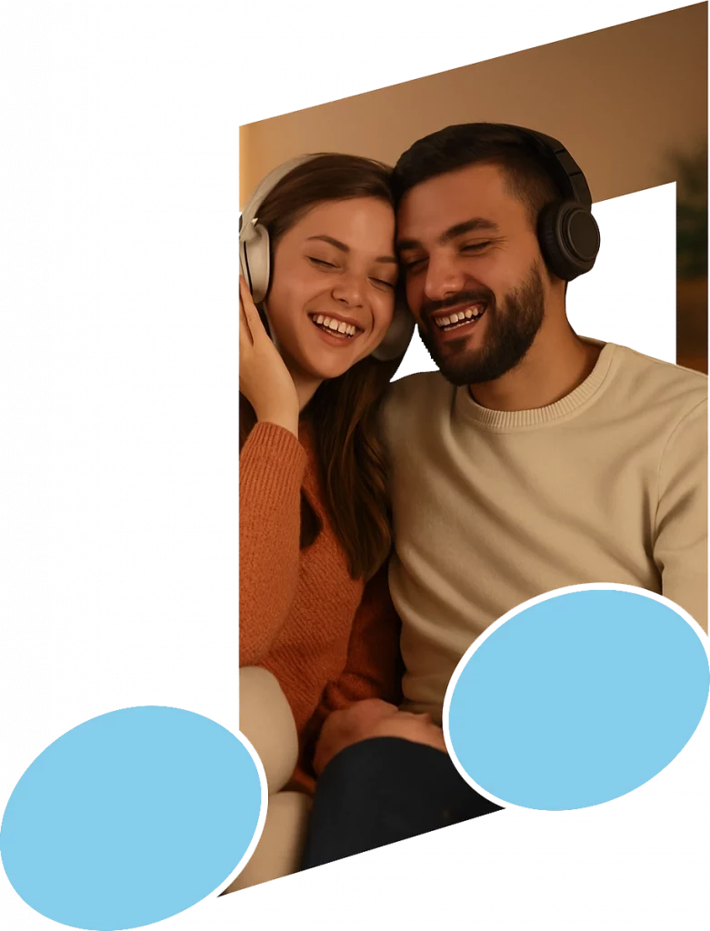 Glückliches Paar sitzt gemütlich auf dem Sofa und hört gemeinsam personalisierte Songs in einer warmen, entspannten Wohnzimmer Atmosphäre